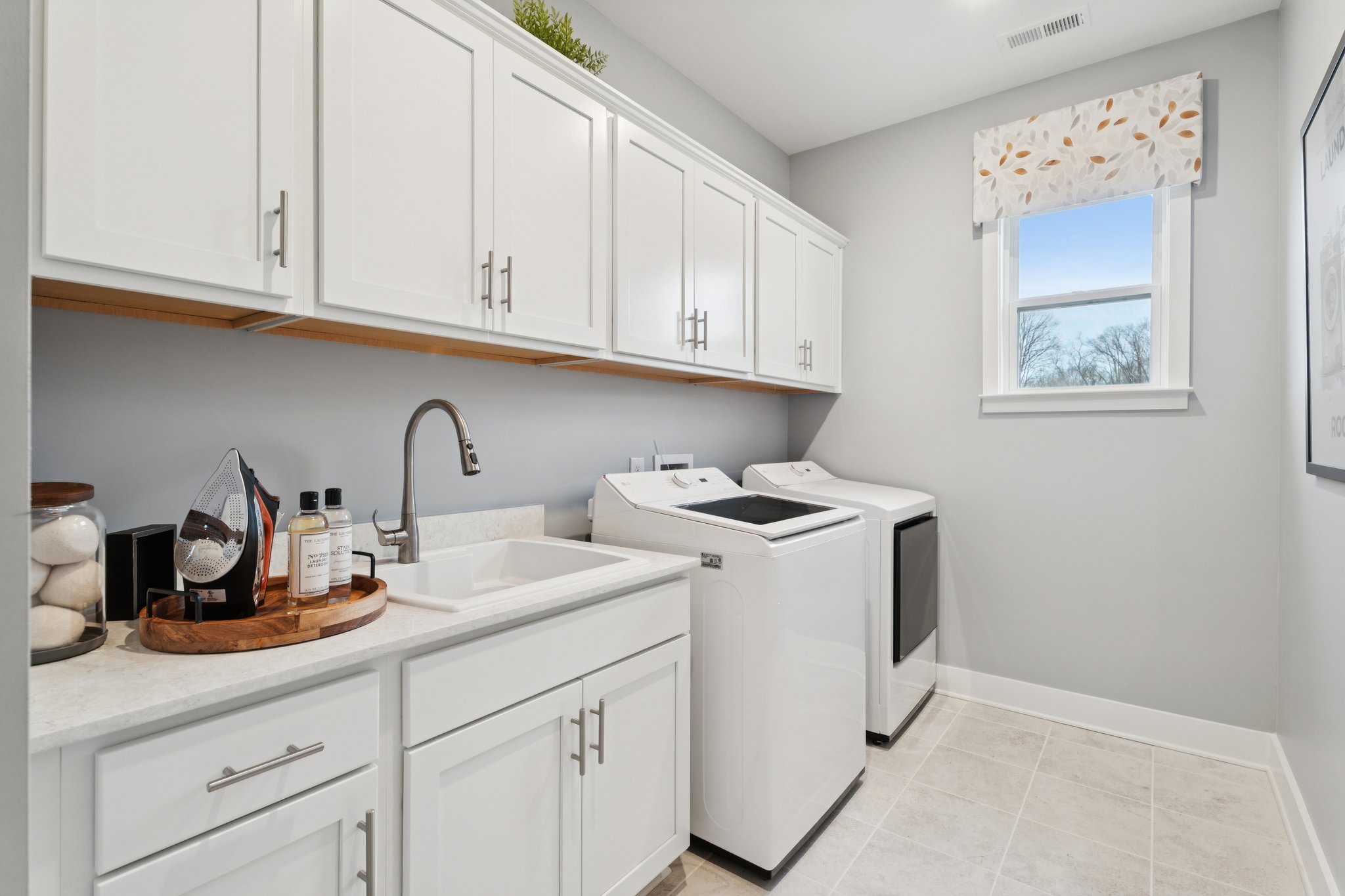 A kitchen with white cabinets.