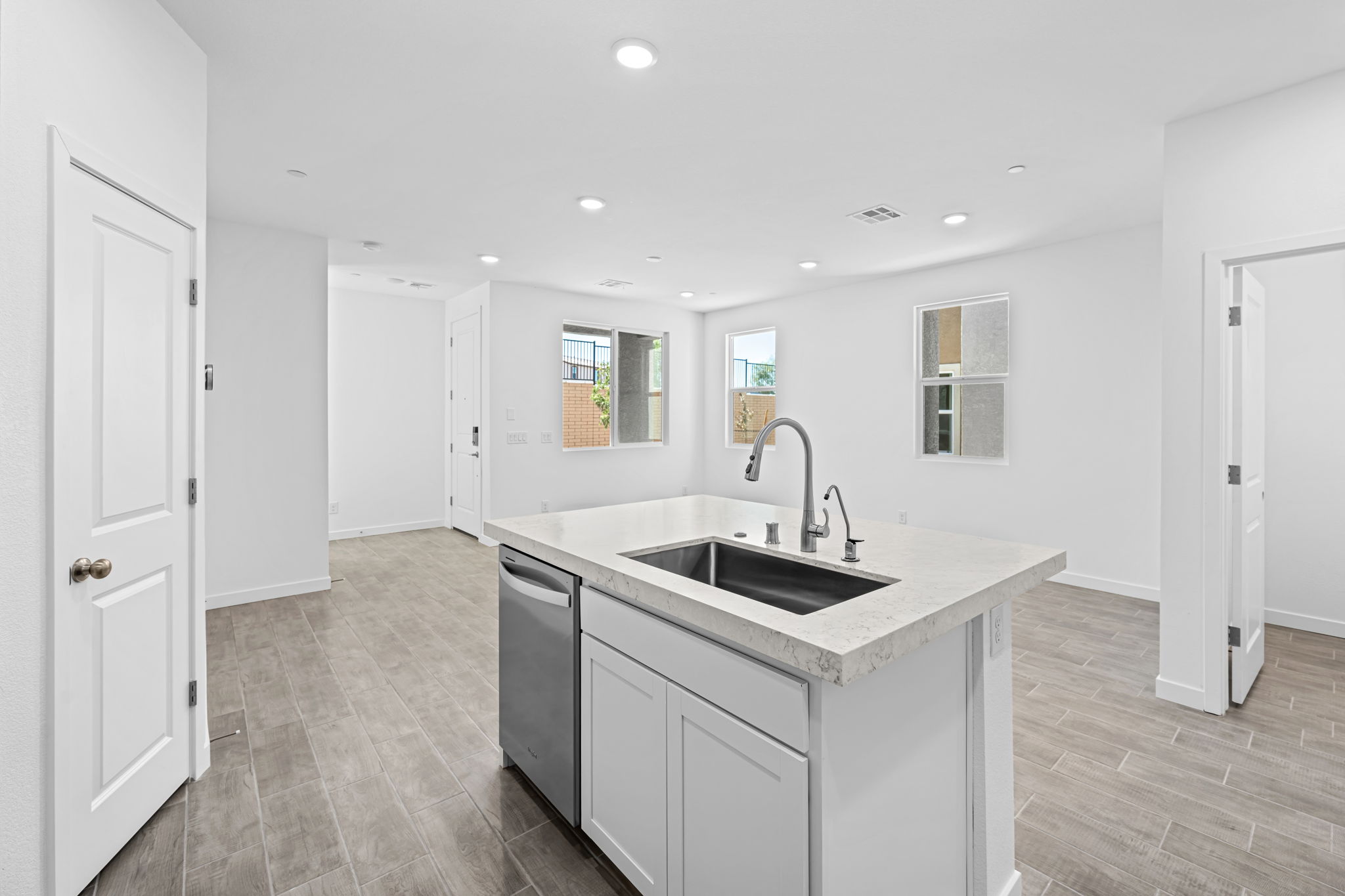A kitchen with white cabinets.