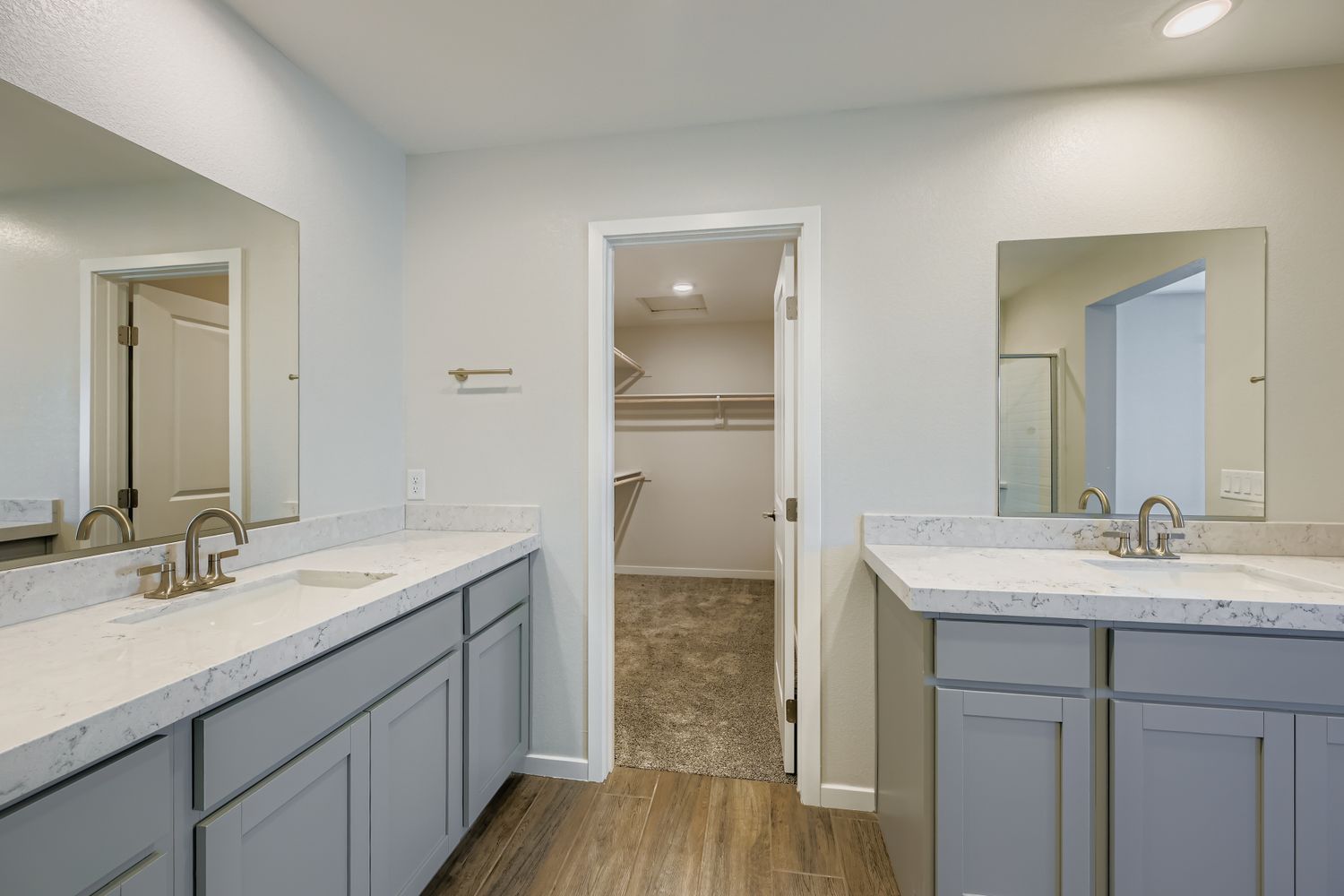 A bathroom with white cabinets.