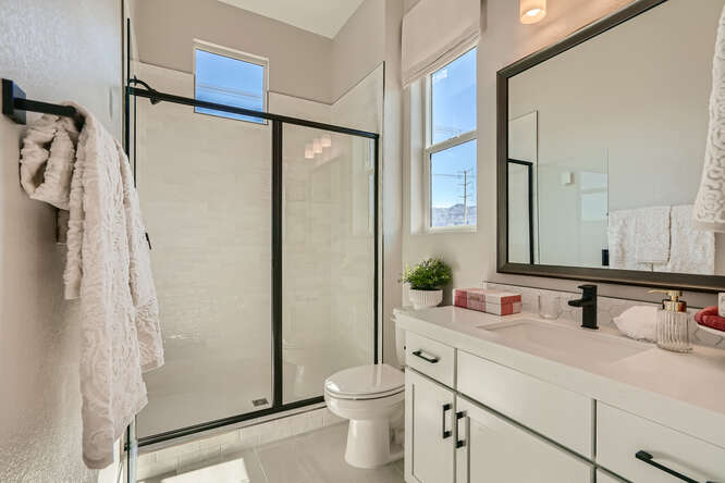A bathroom with a shower and sink.
