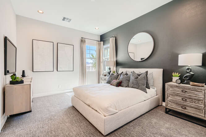 A room with a bed and a mirror.