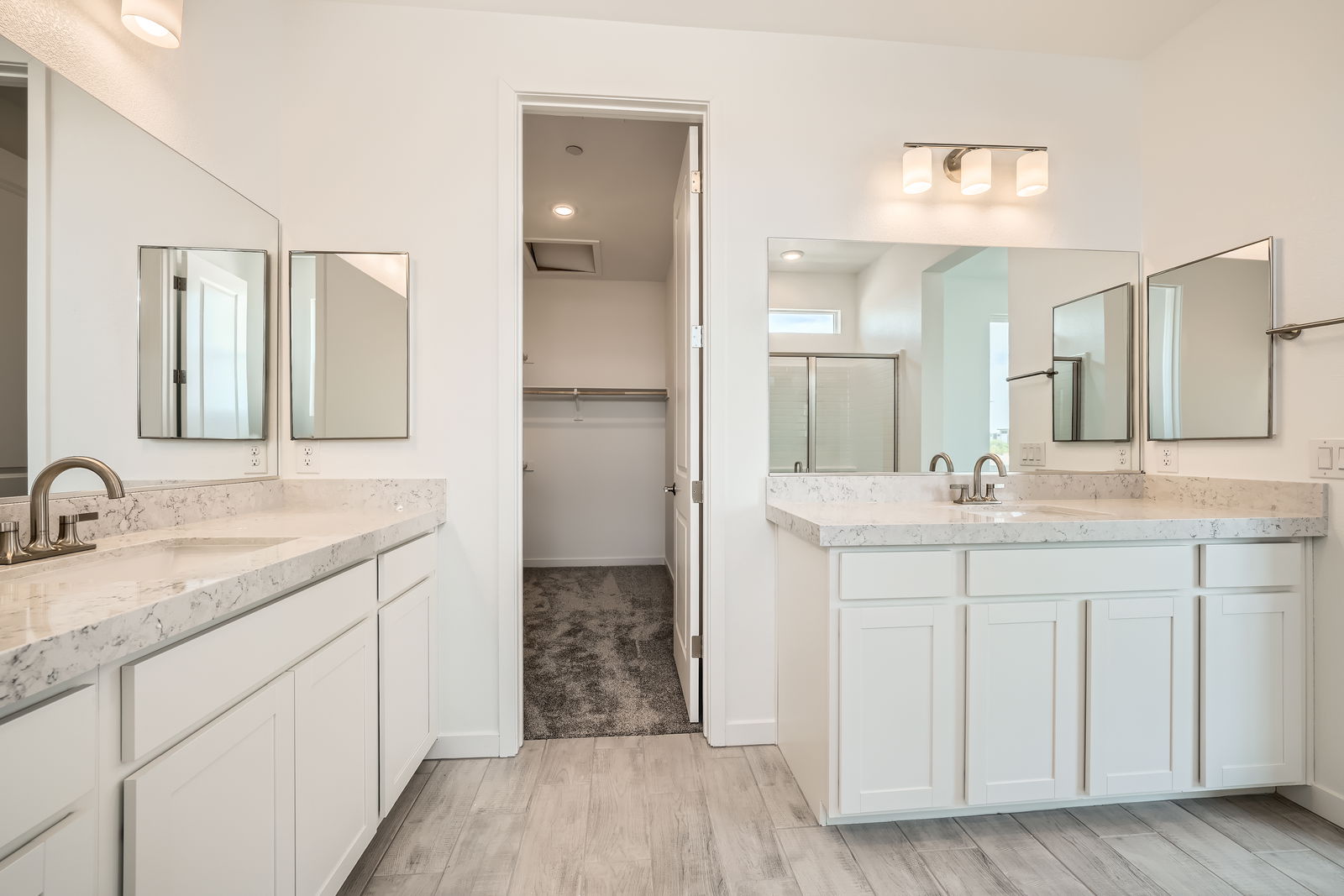 A bathroom with white cabinets.
