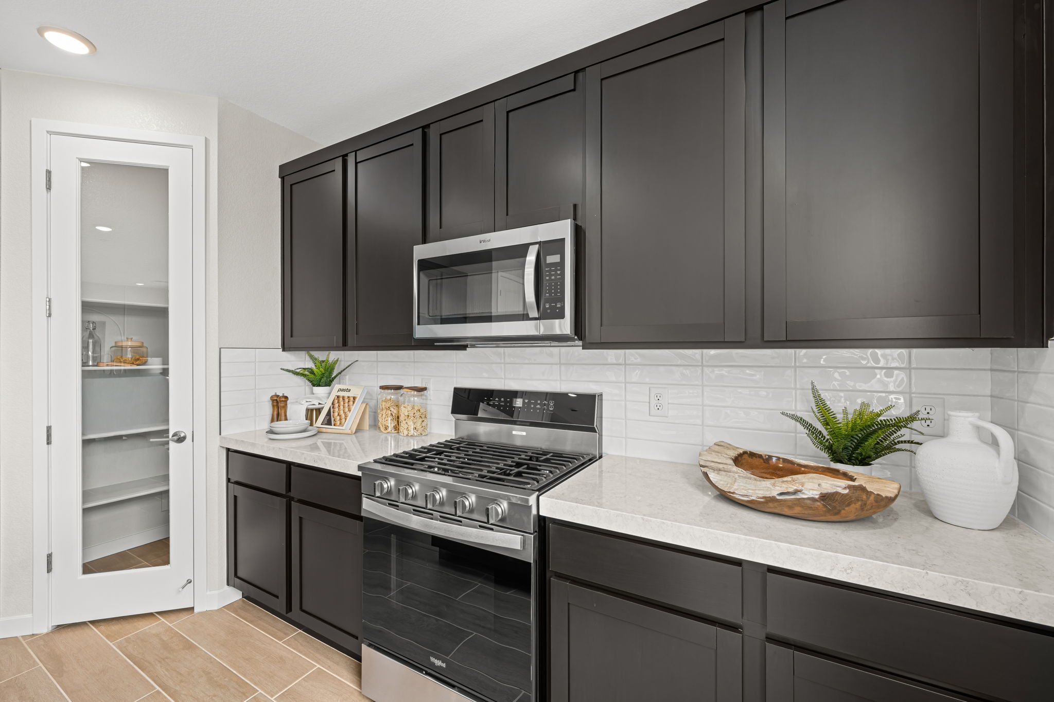 A kitchen with black cabinets.