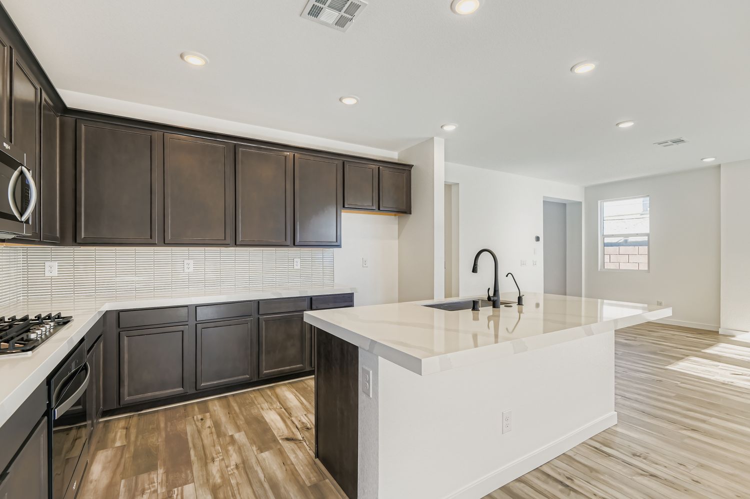A kitchen with black cabinets.