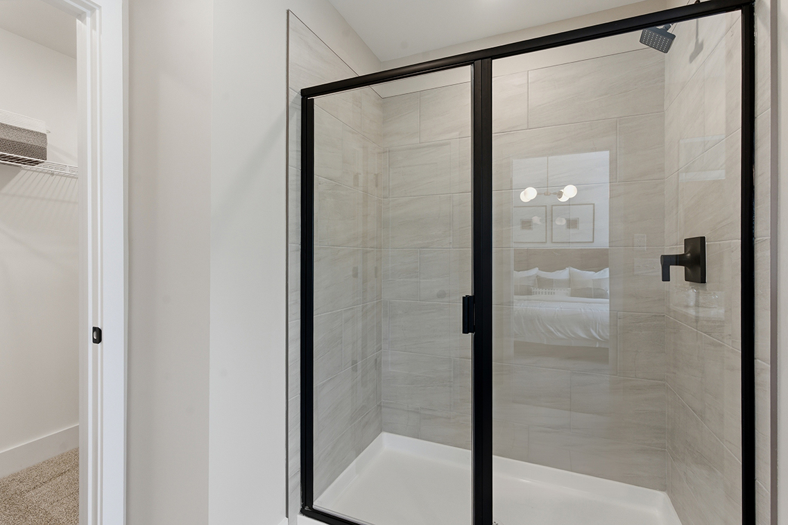 A shower with a glass door.