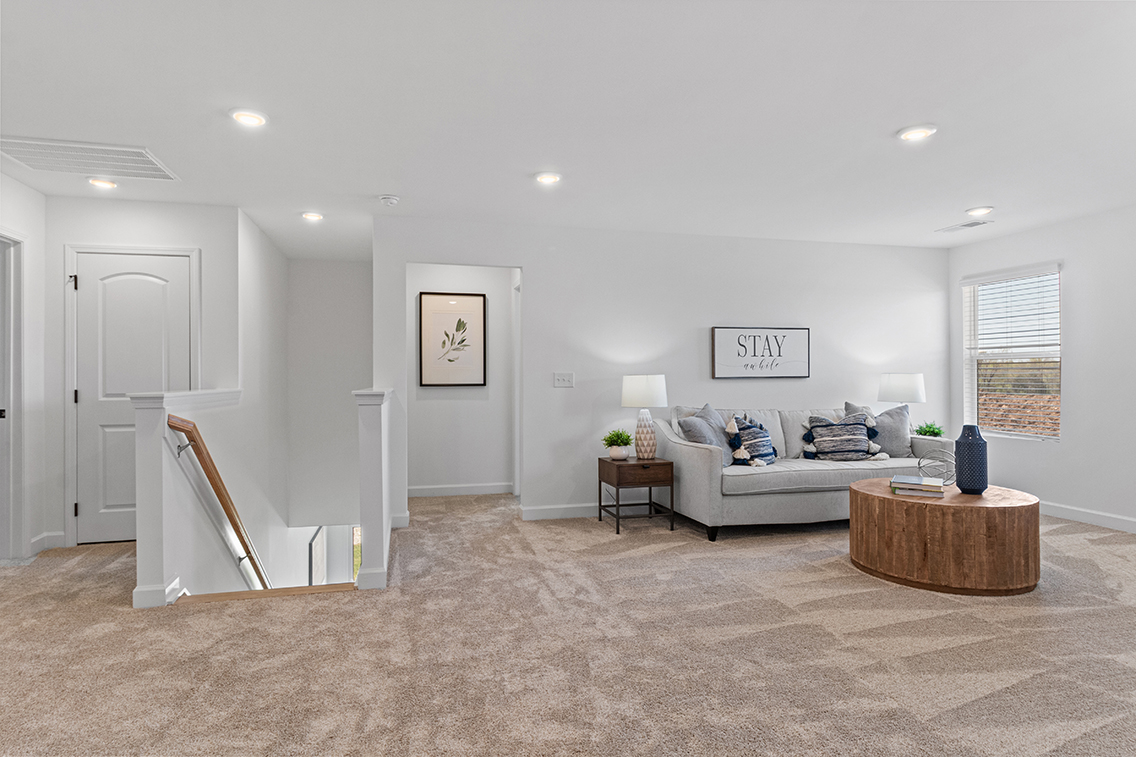 A living room with a couch and a table.