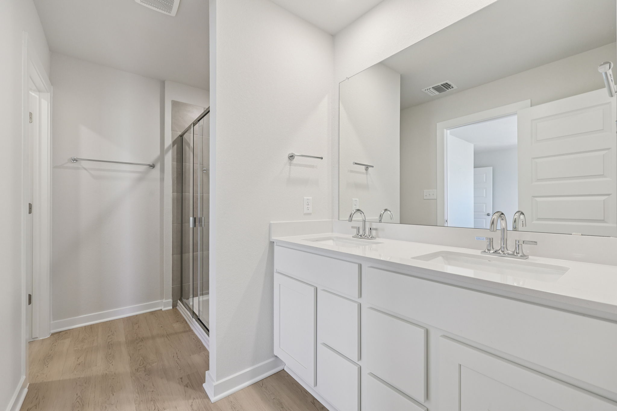 A bathroom with white cabinets.