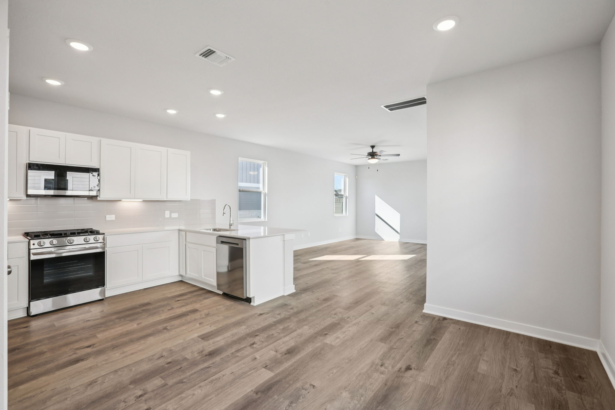 A kitchen with white cabinets.
