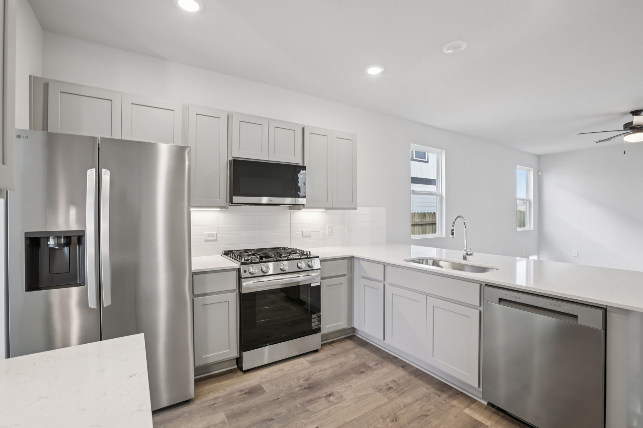 A kitchen with white cabinets.