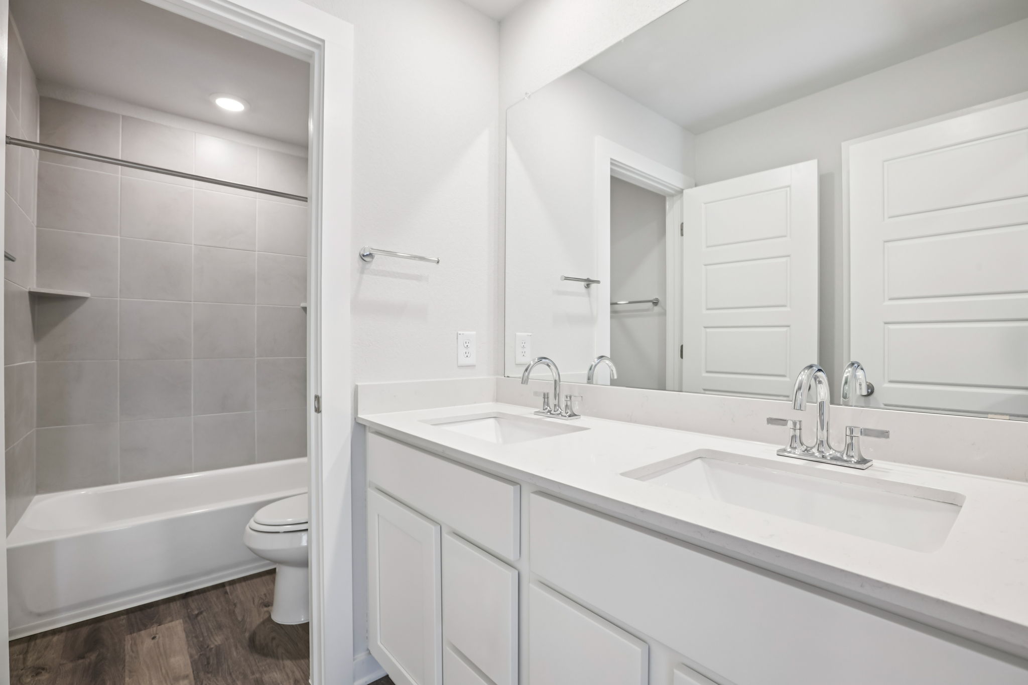 A bathroom with a tub sink and toilet.