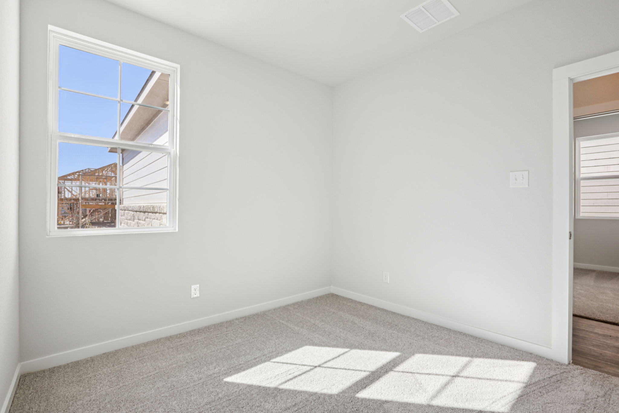 A room with a window and a tile floor.