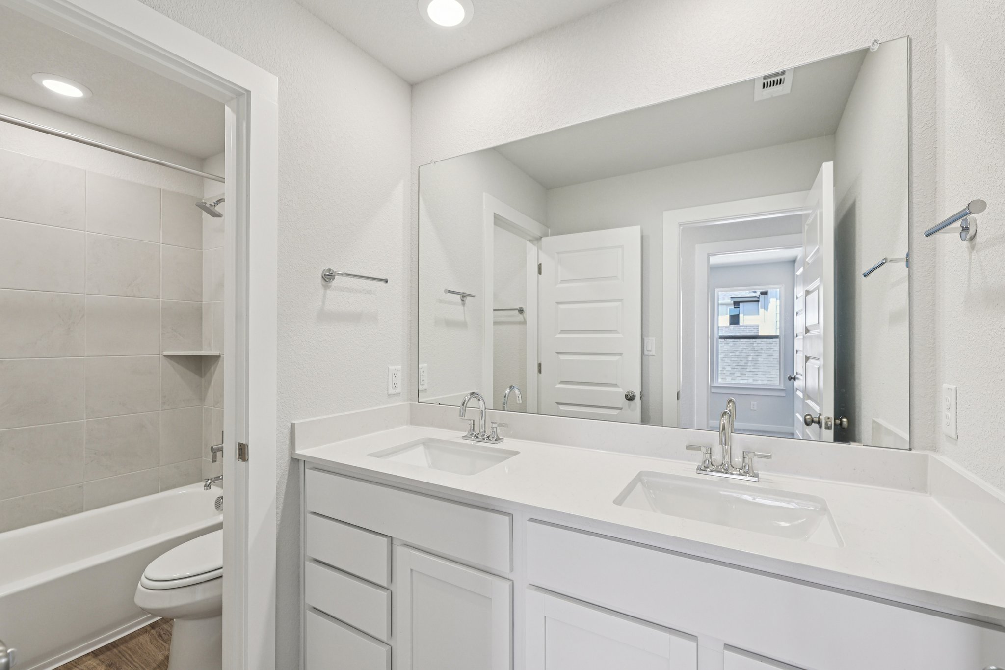 A bathroom with a tub sink and toilet.
