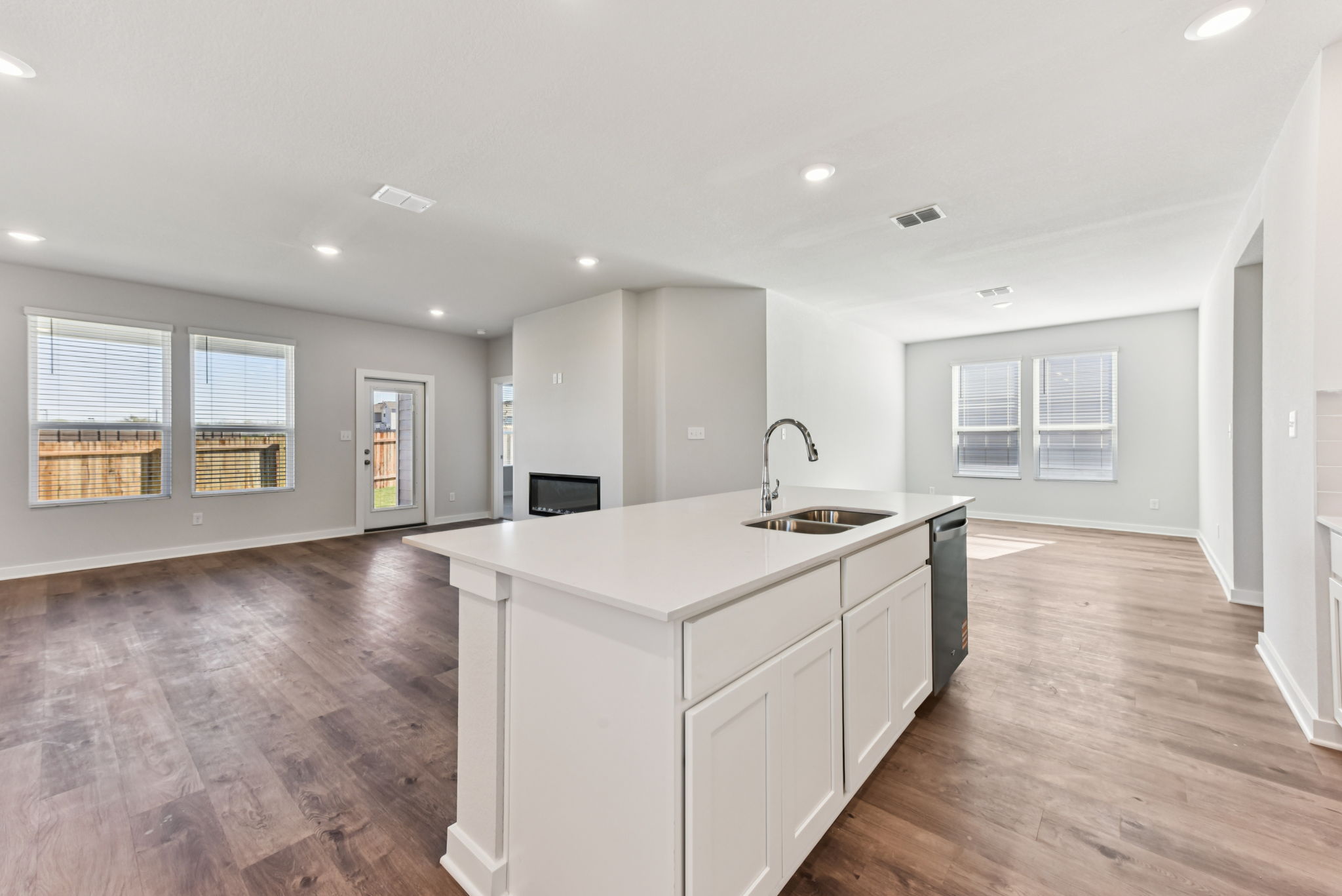 A kitchen with white cabinets.