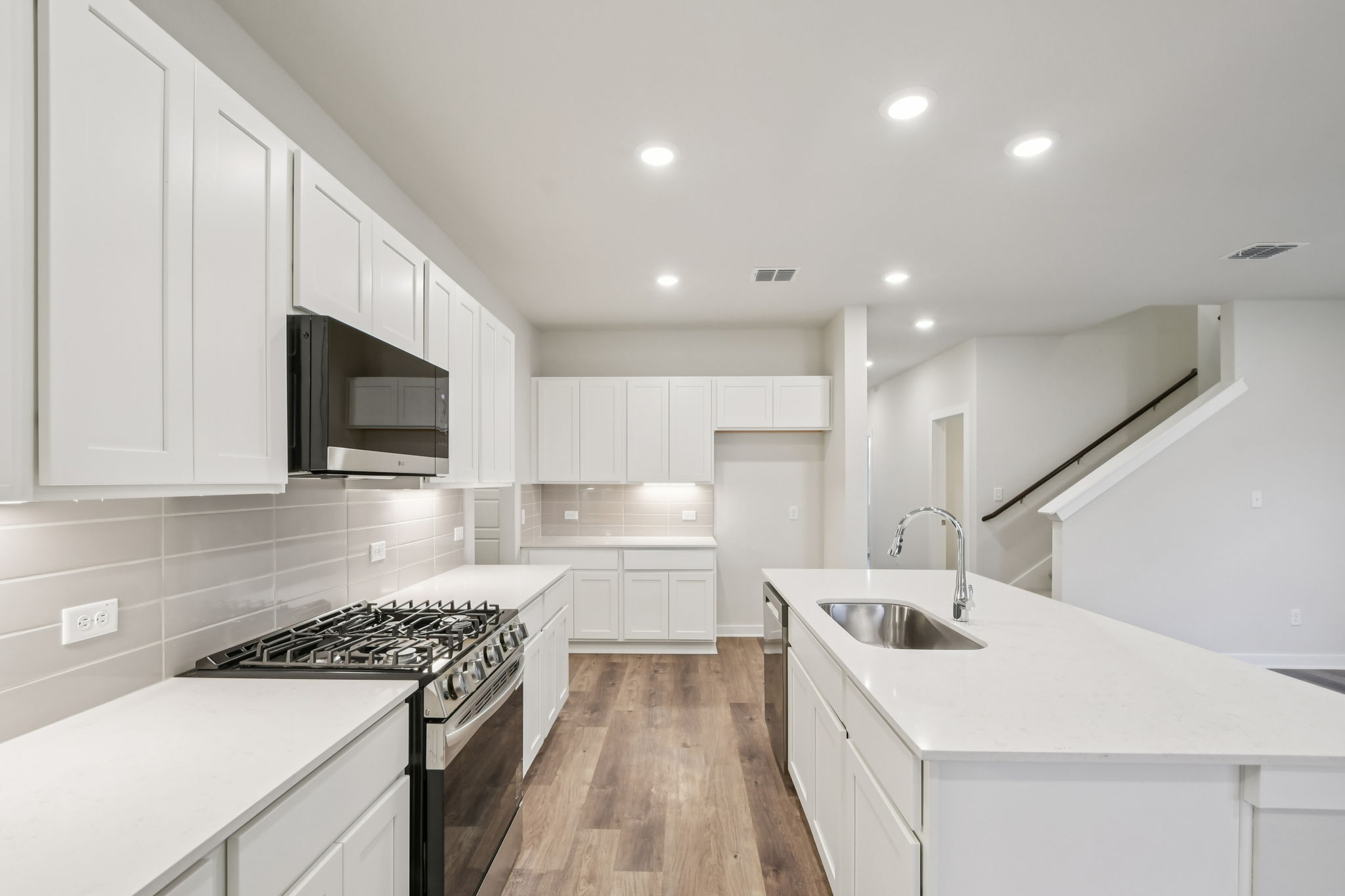 A kitchen with white cabinets.