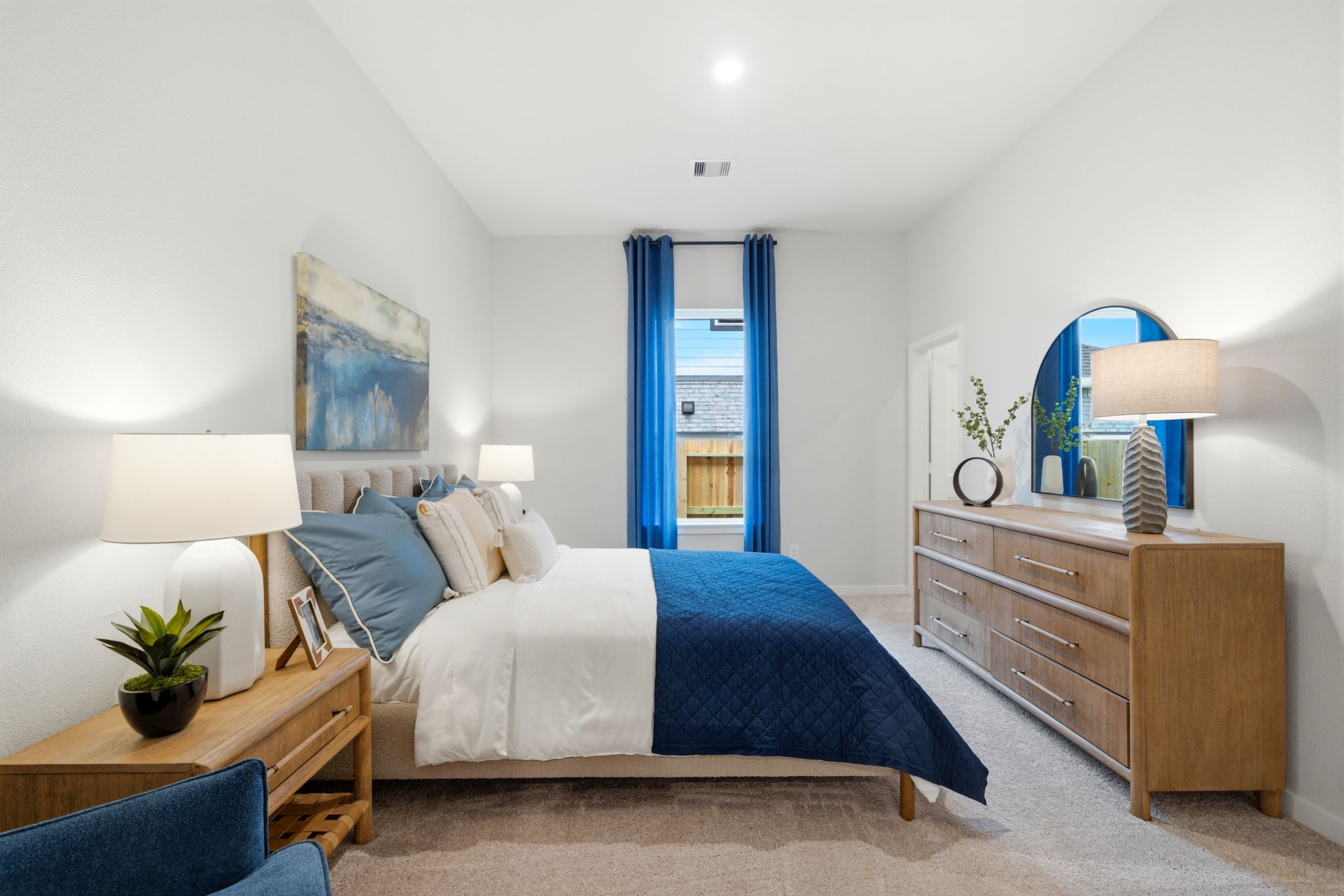 A bedroom with a bed and a dresser.