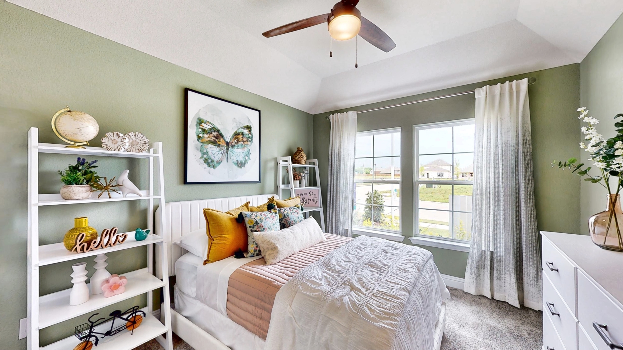 A bedroom with a bed and a shelf with objects on it.