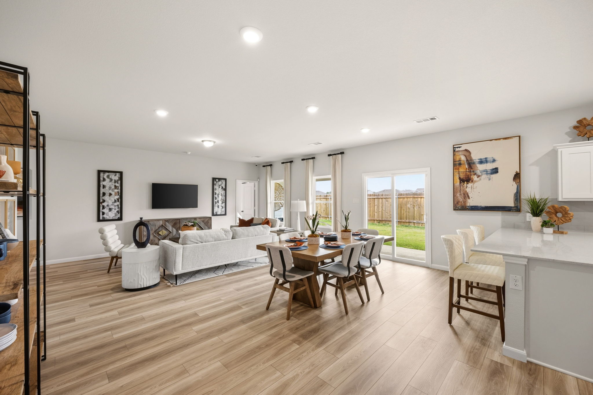A large living room with a wood floor.