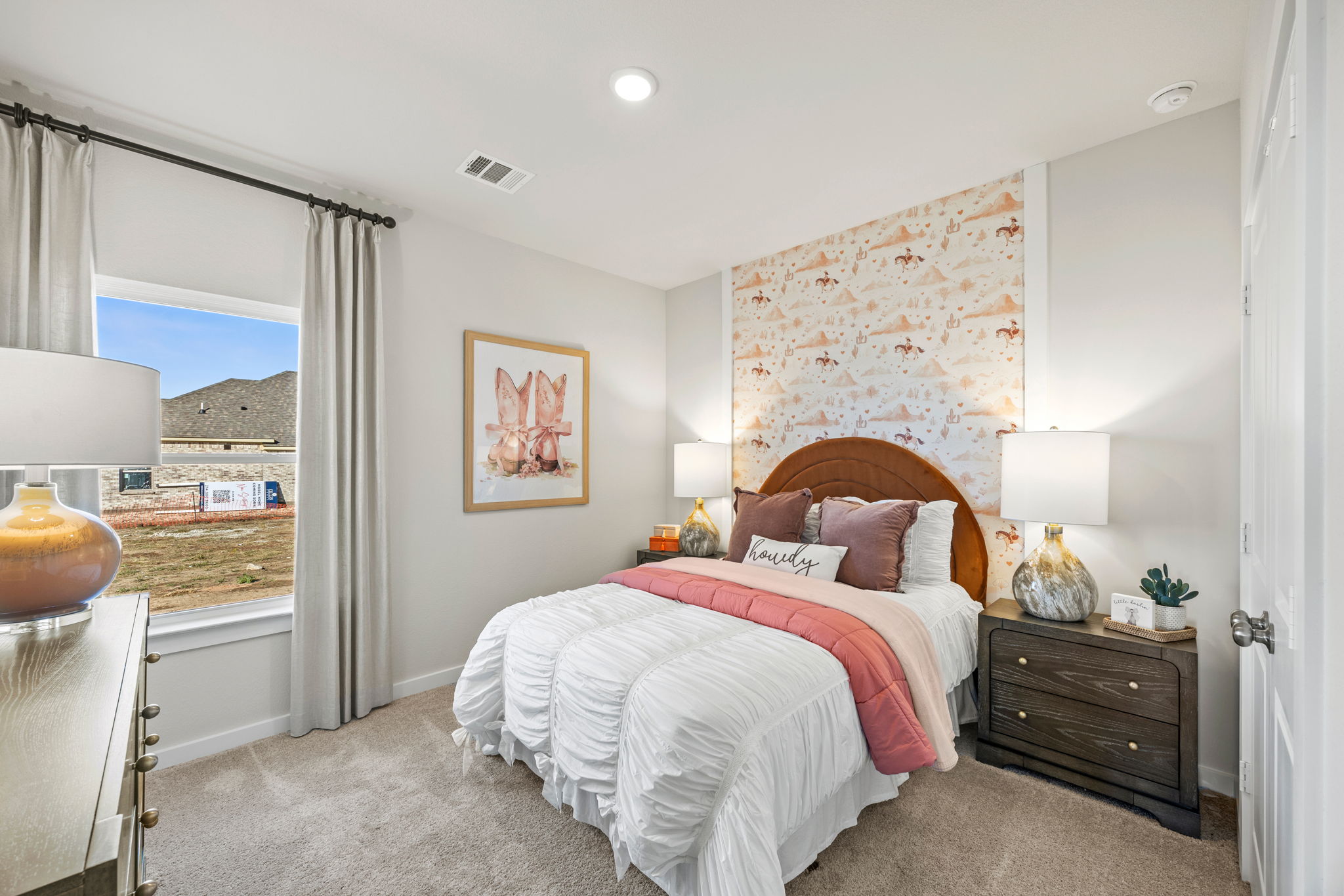 A bedroom with a bed and a window.