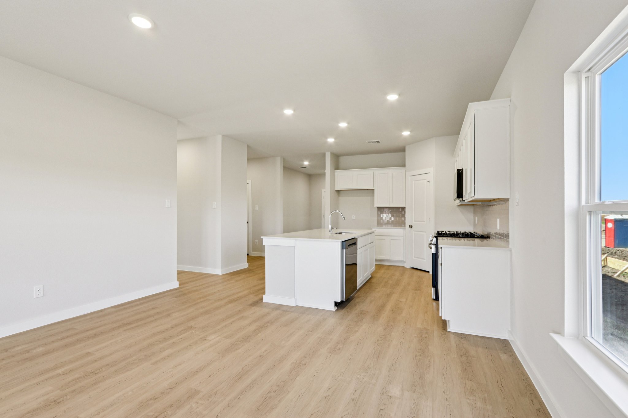 A kitchen with white cabinets.