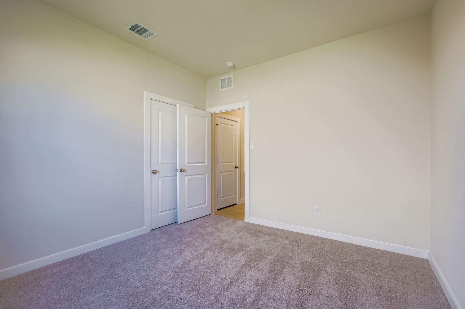 A hallway with white doors.