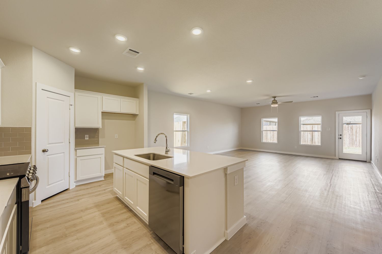 A kitchen with white cabinets.