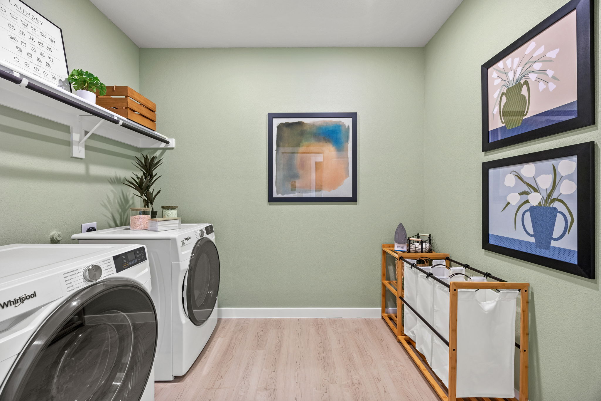 A room with a washing machine and a table.