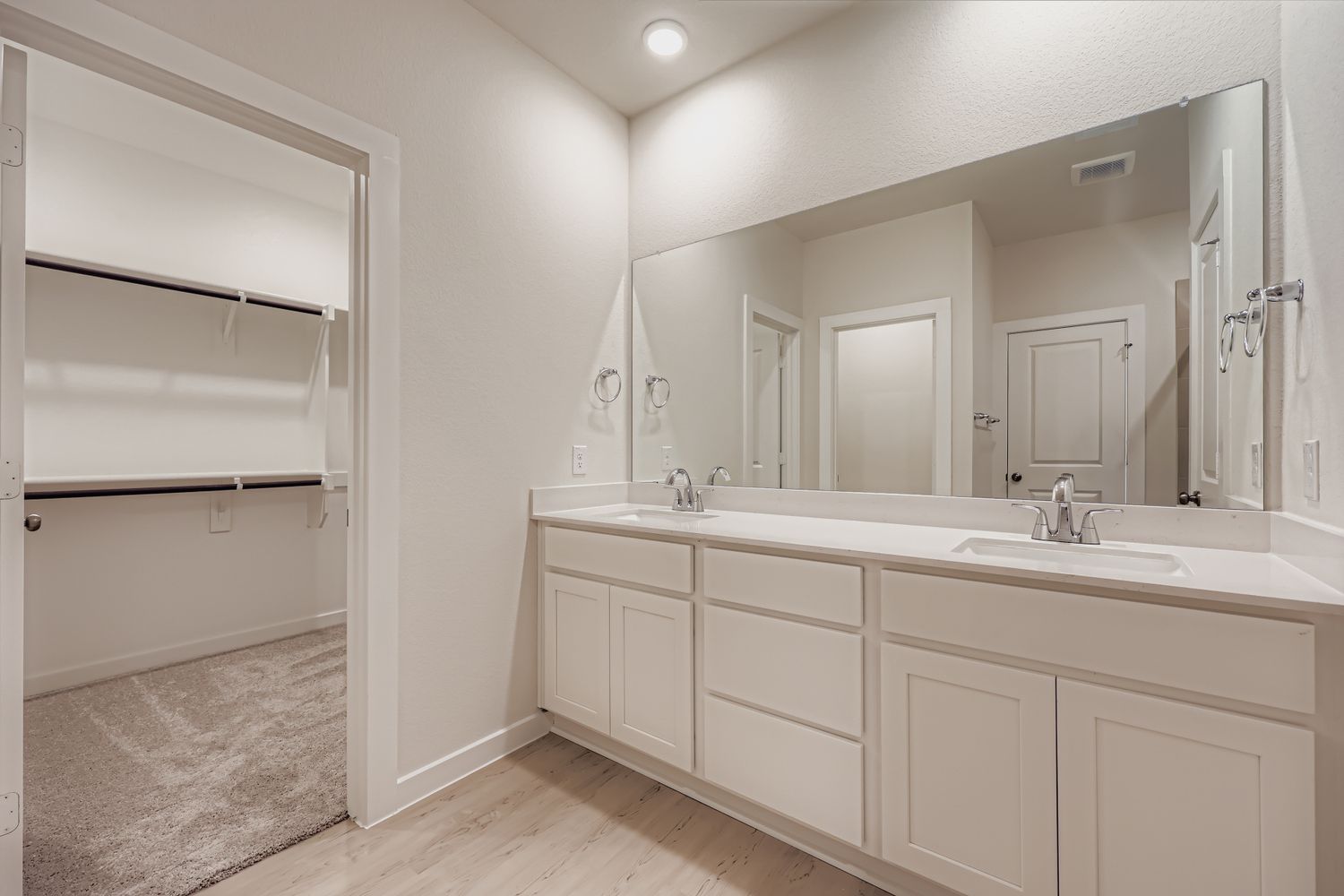 A bathroom with a large mirror.