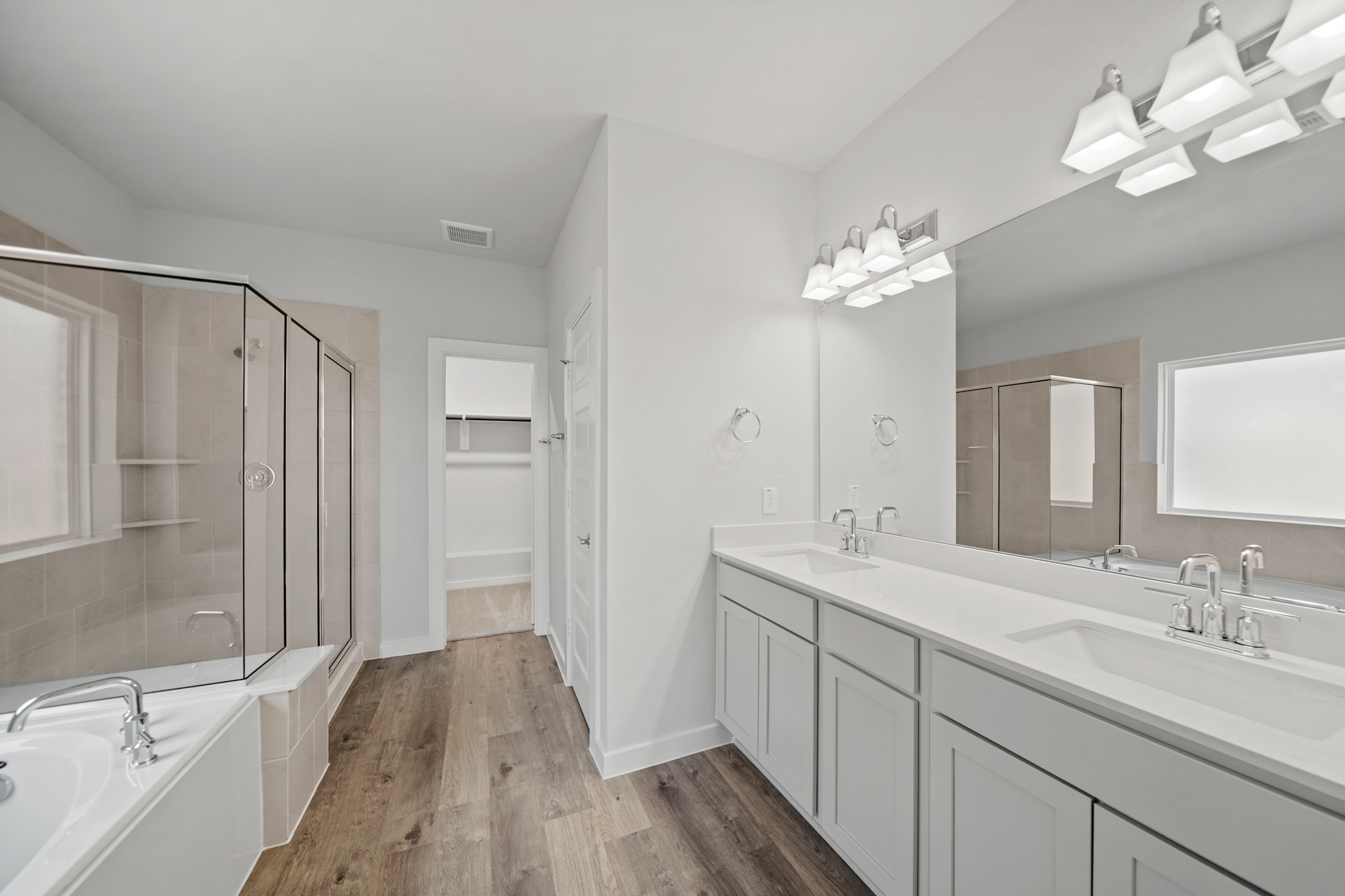 A bathroom with a large mirror.