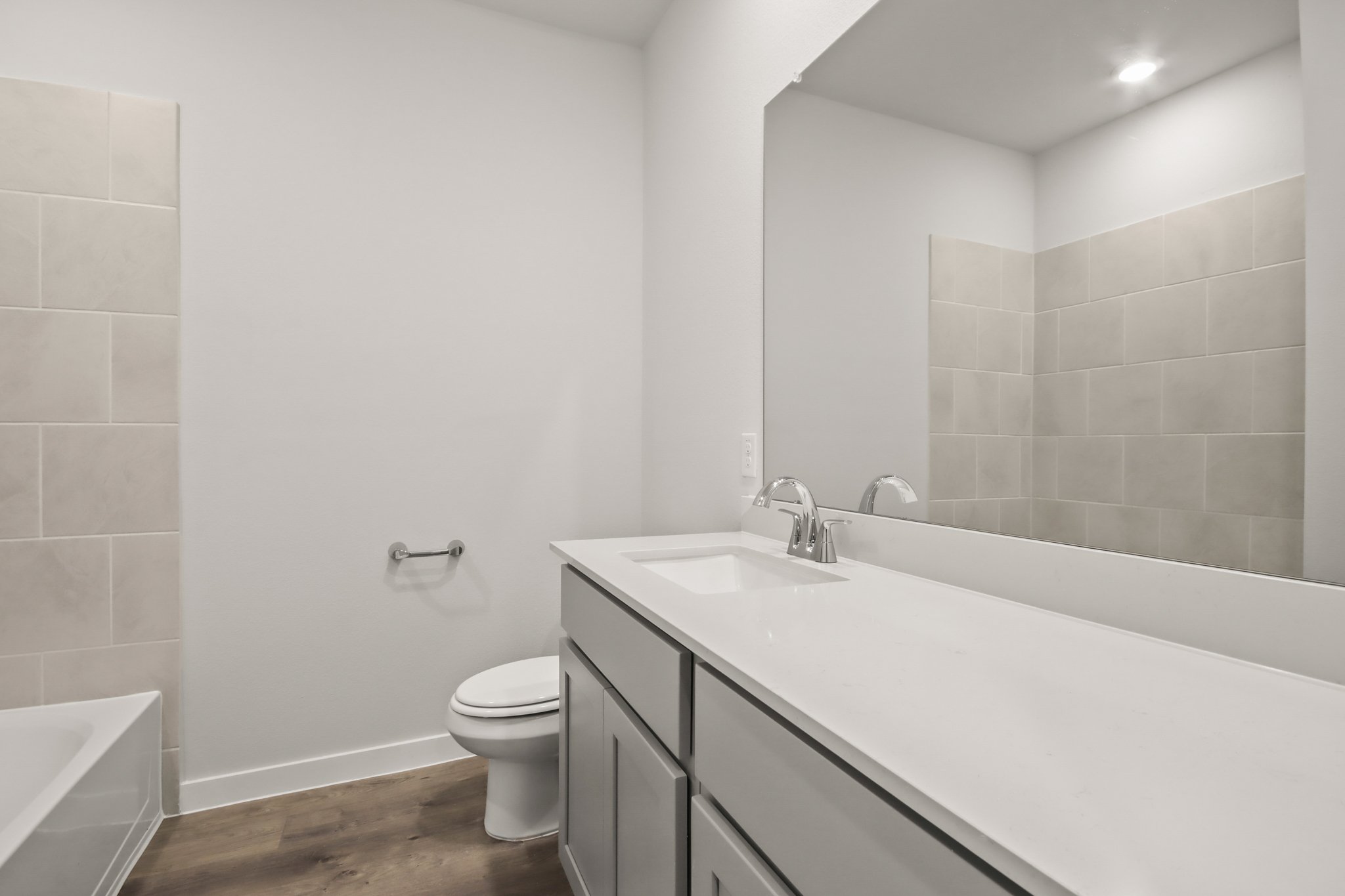 A bathroom with a tub sink and toilet.