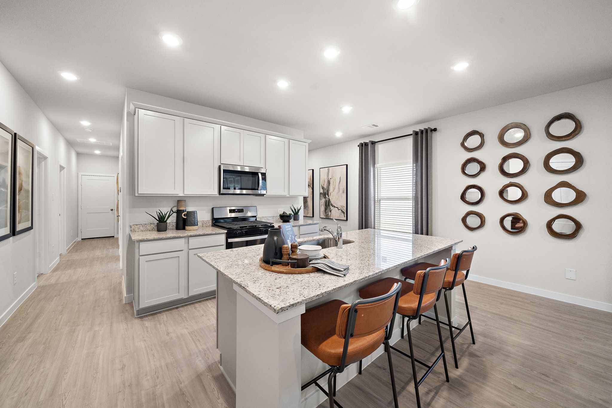 A kitchen with a dining table and chairs.