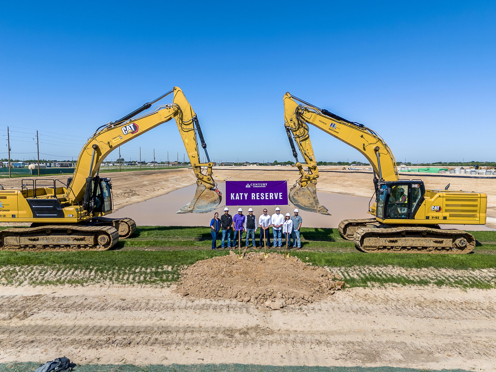 A group of people standing in front of a construction site.