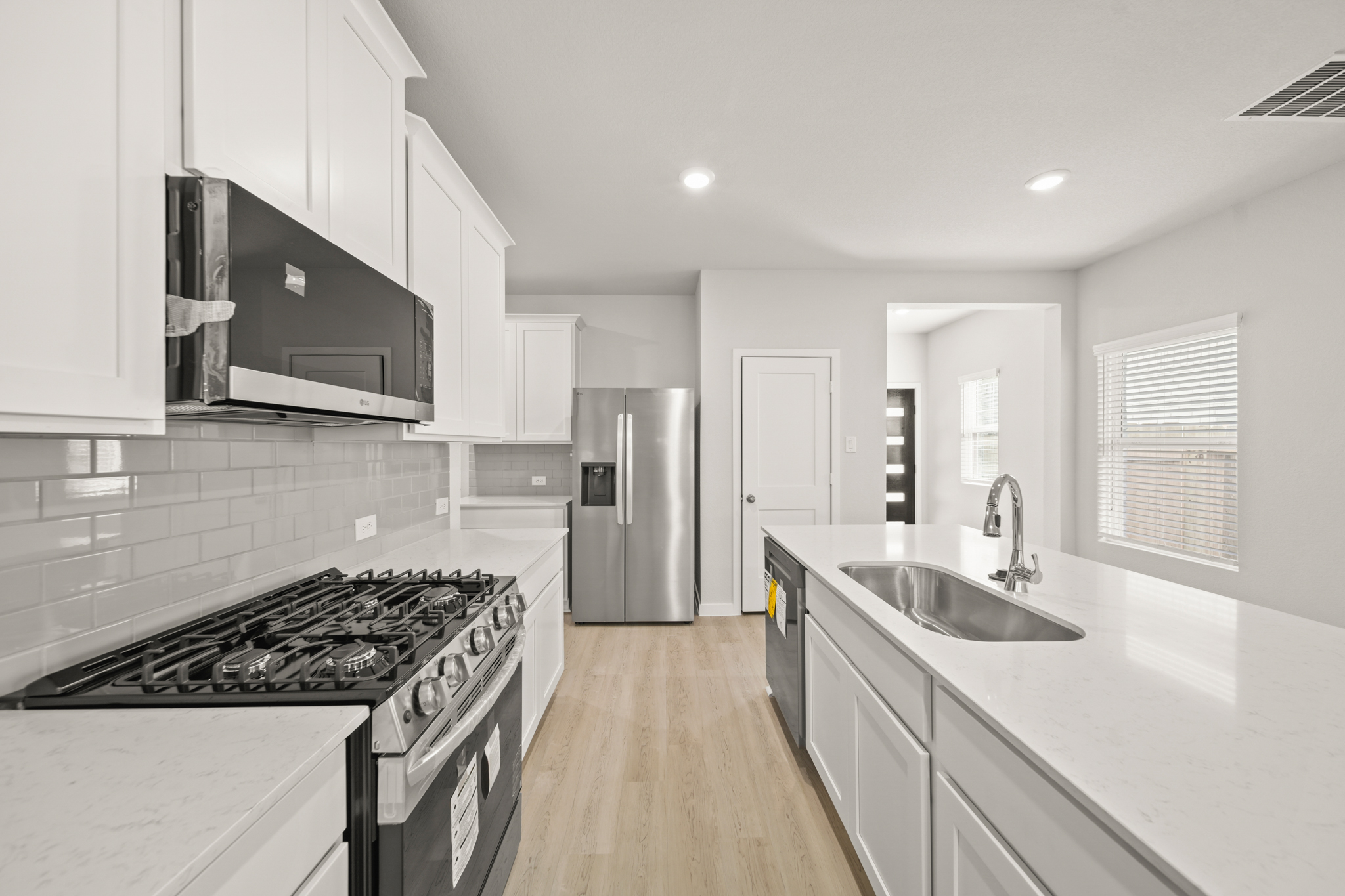A kitchen with white cabinets.