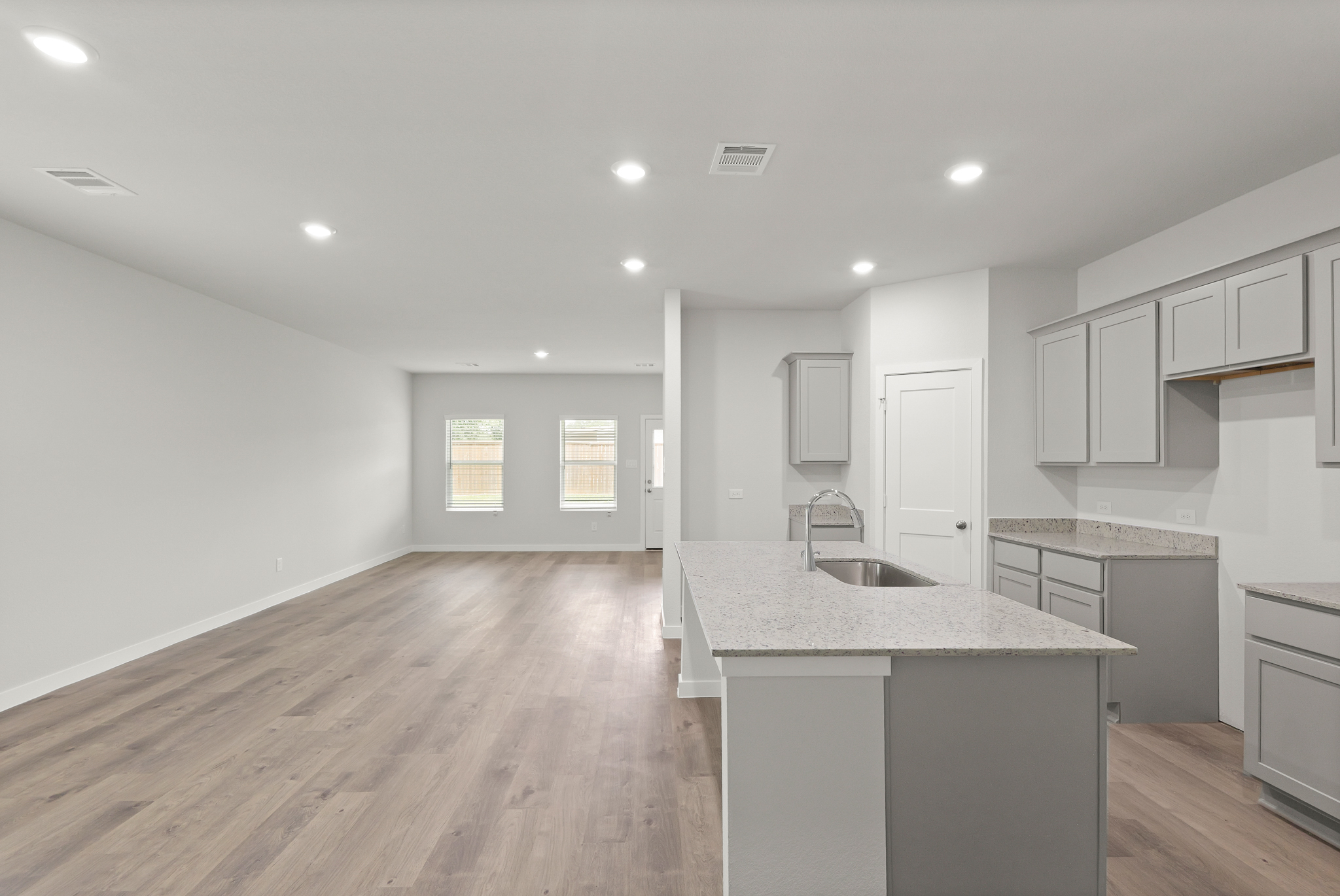 A kitchen with white cabinets.