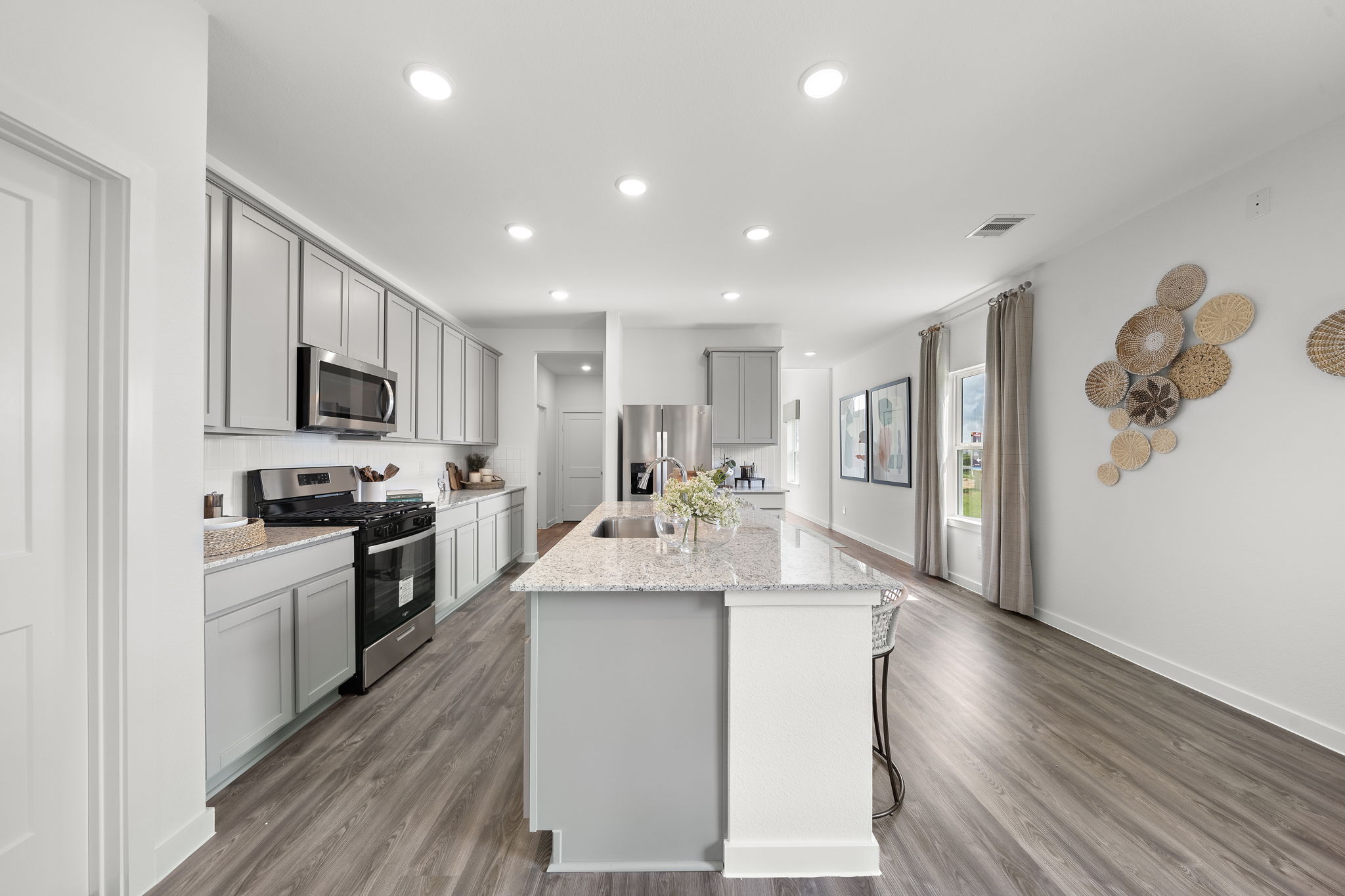 A kitchen with a marble island.