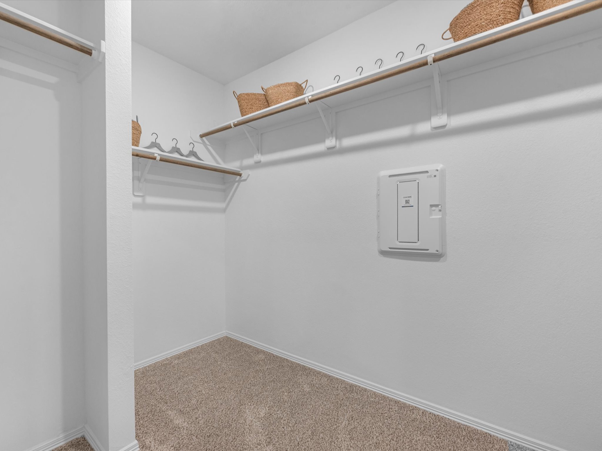 A white wall with a light switch.