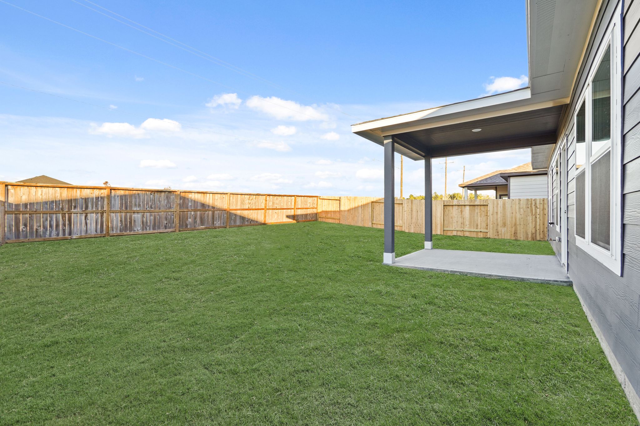 A green lawn next to a building.