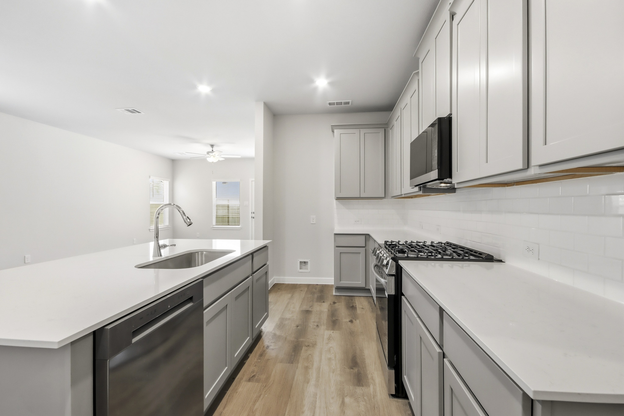 A kitchen with white cabinets.