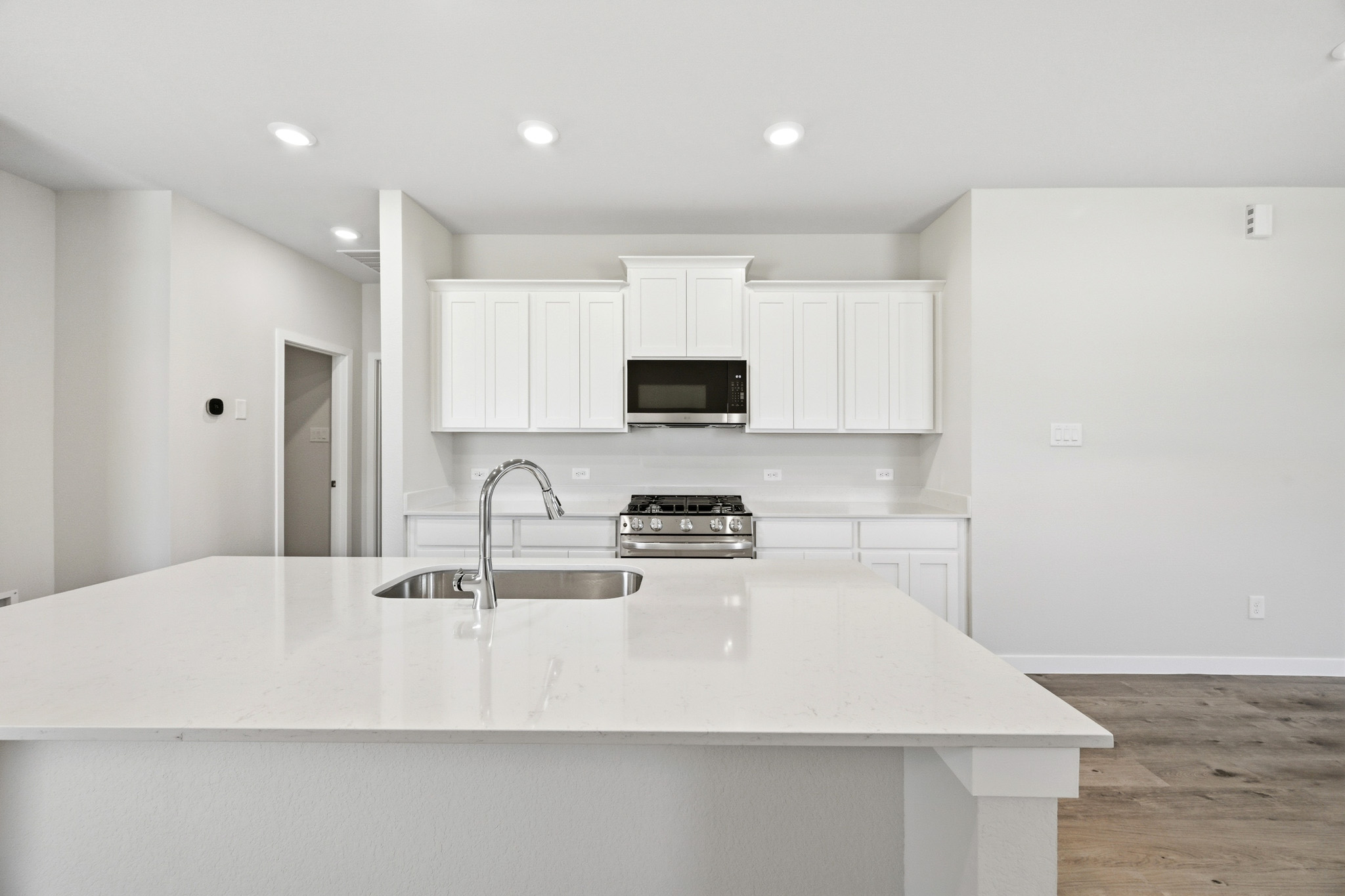 A kitchen with white cabinets.