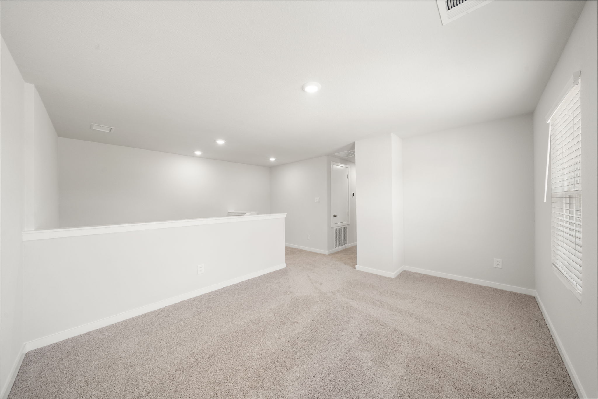 A long hallway with white walls.