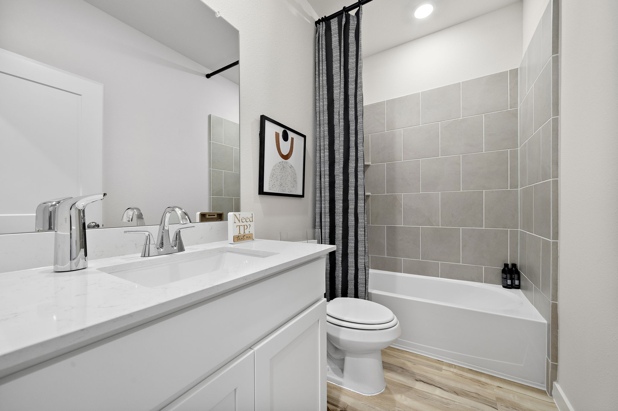 A bathroom with a tub sink and toilet.