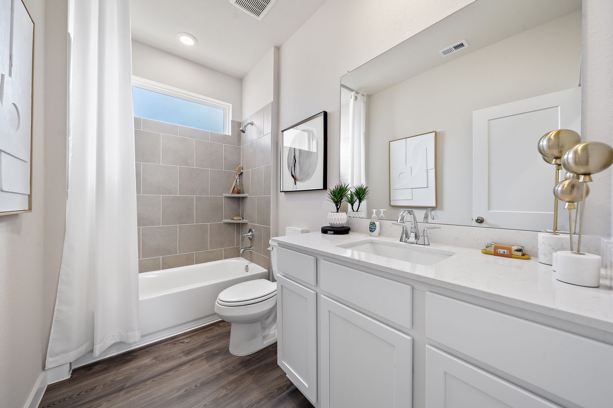A bathroom with a tub sink and toilet.