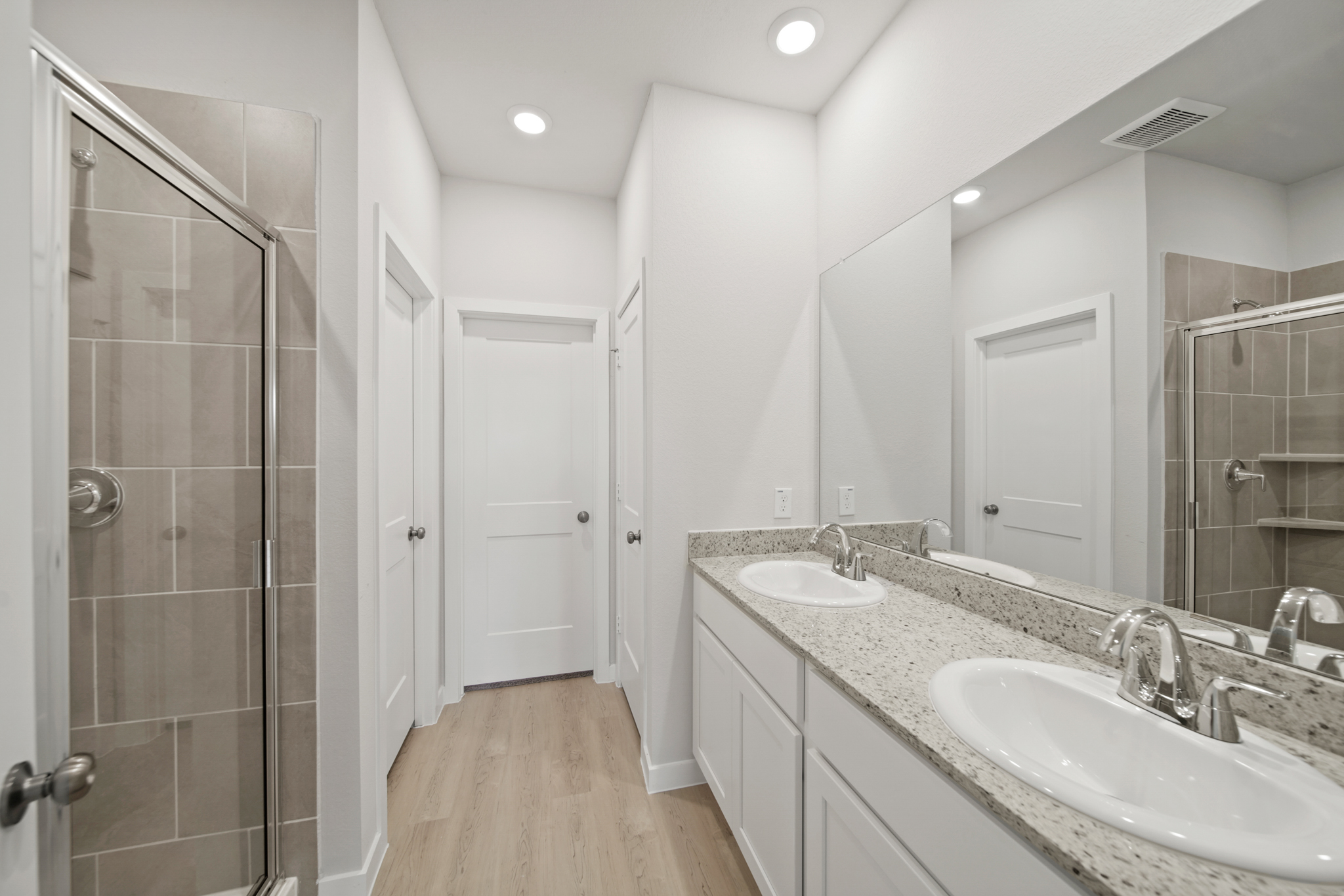 A bathroom with a large mirror.