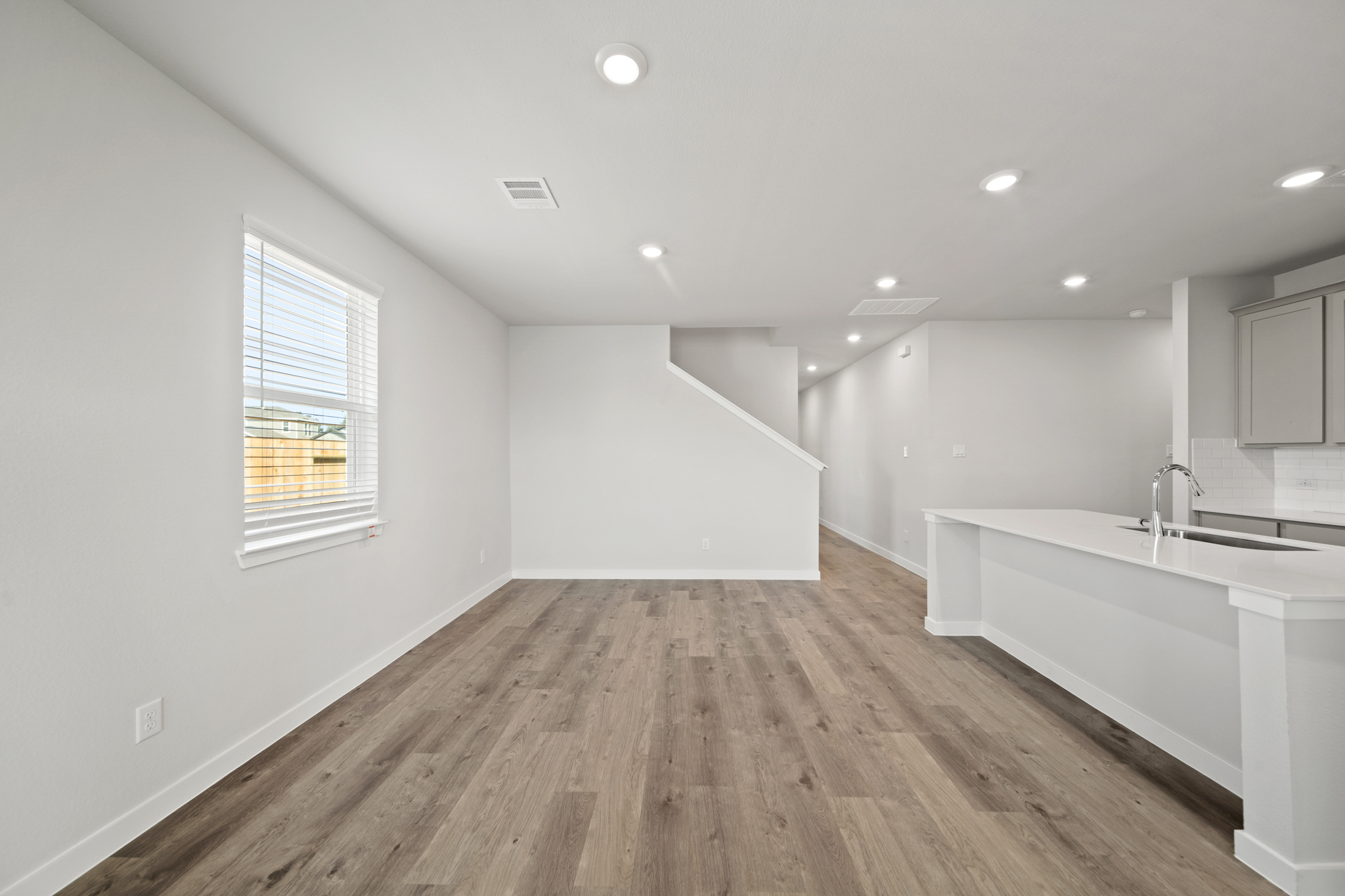A bathroom with a tub sink and a window.