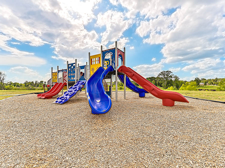 A playground with blue and red slide.
