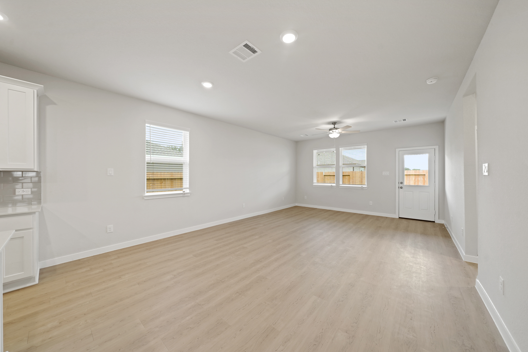 A room with a wood floor and white walls.