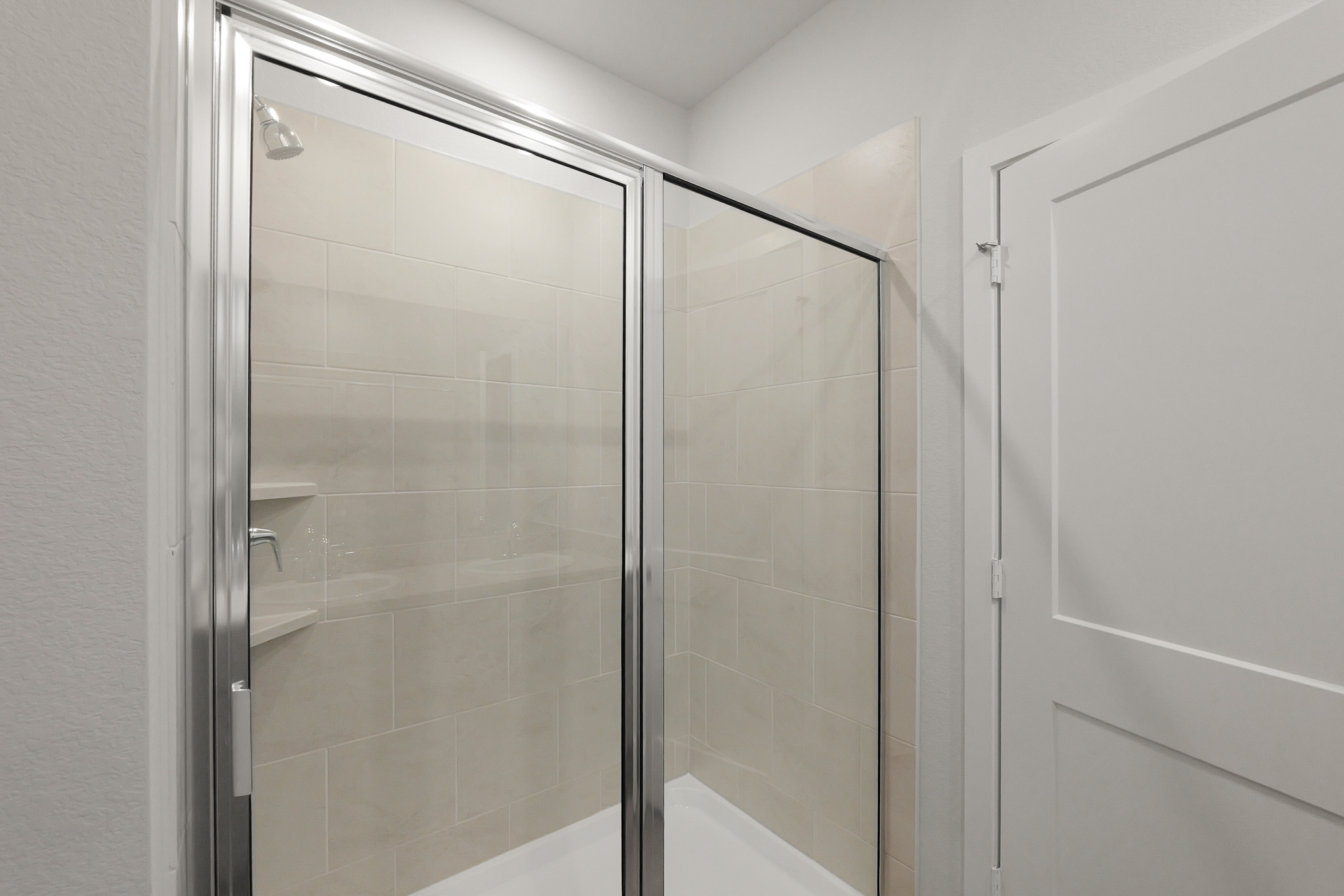 A shower with a glass door.