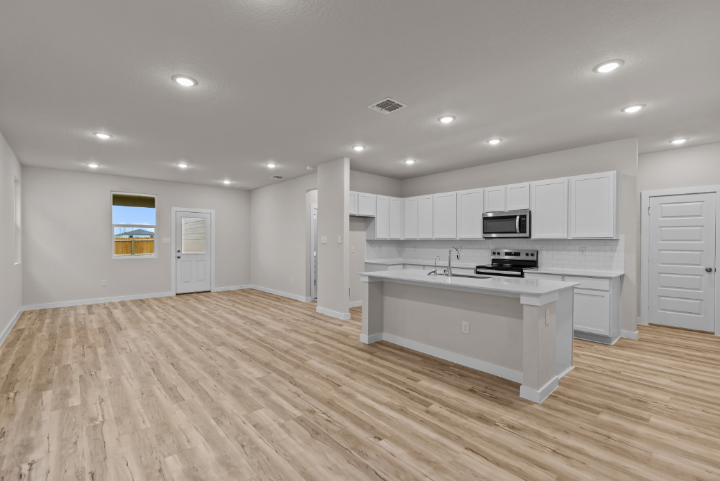 A kitchen with white cabinets.