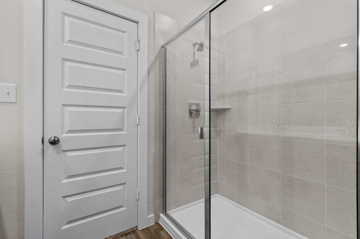 A shower with a glass door.