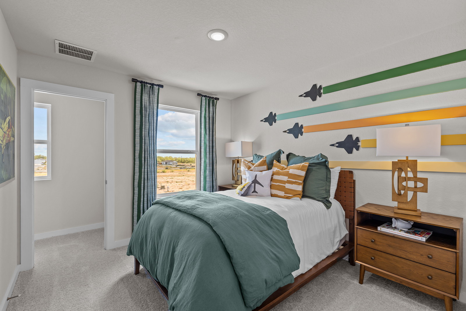 A bedroom with a bed and a desk.