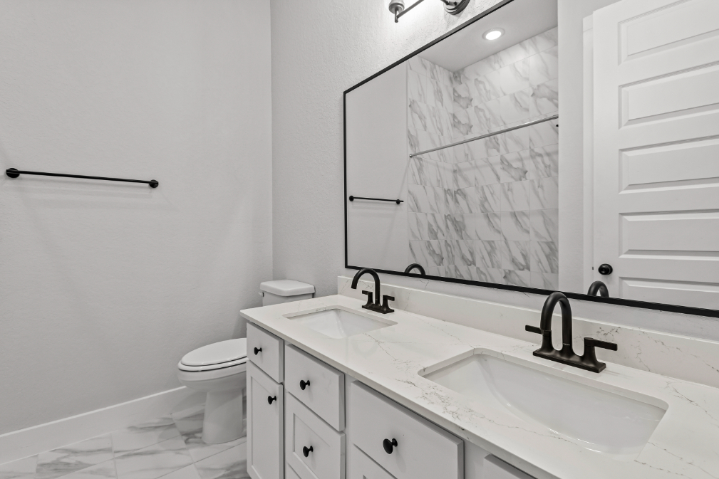 A bathroom with a large mirror.